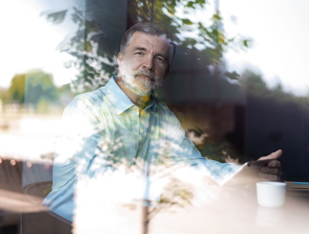 Man looking through the window, photo from outside 